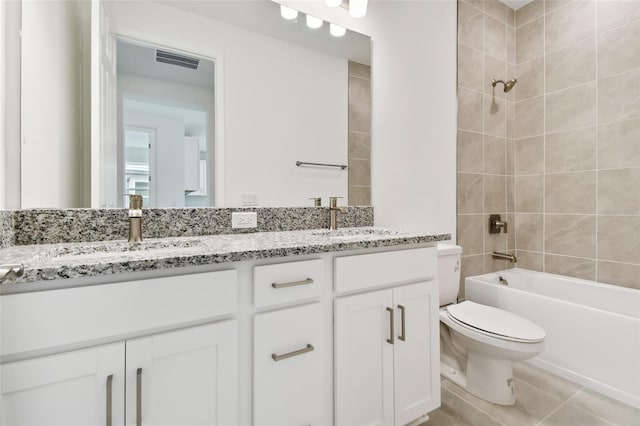 full bathroom with toilet, vanity, tile patterned floors, and tiled shower / bath