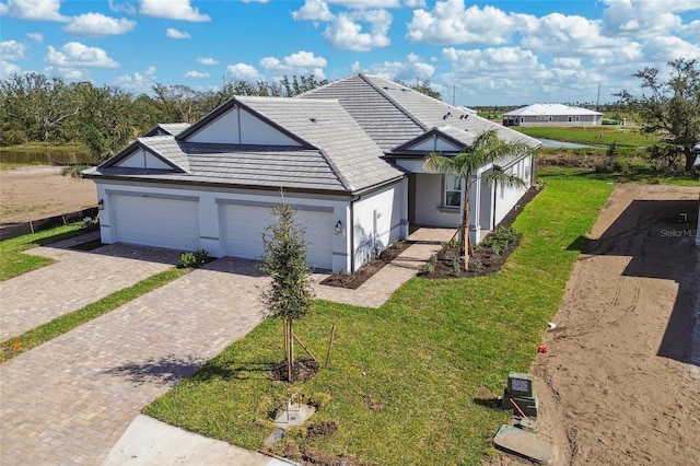 single story home with a garage and a front yard