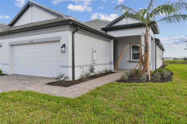 view of front of house with a front yard and a garage