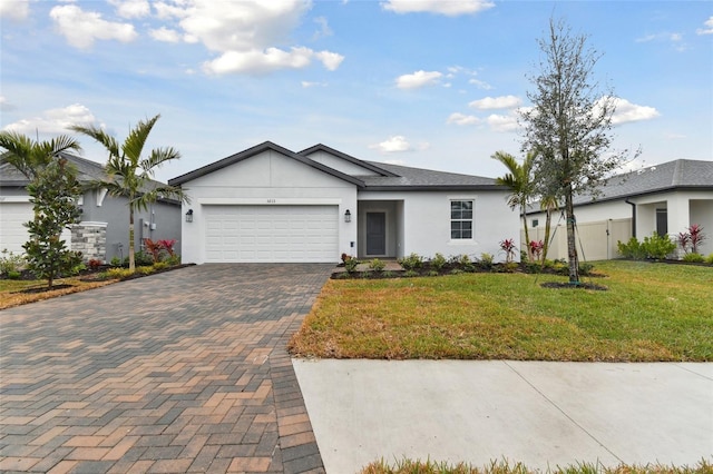 ranch-style house featuring a garage and a front lawn