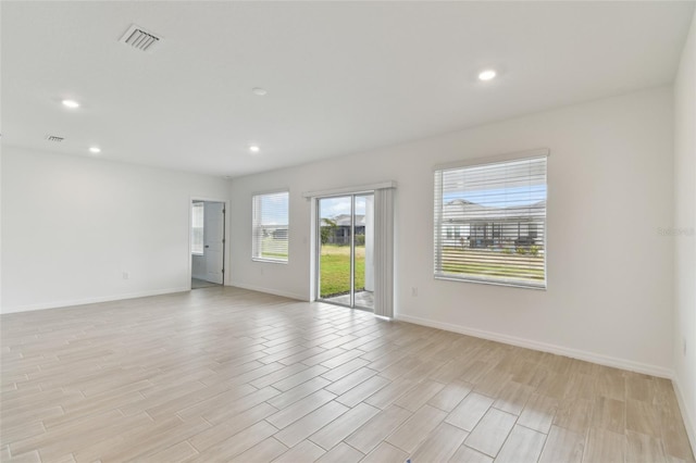 unfurnished room with light hardwood / wood-style flooring