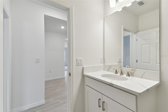 bathroom featuring hardwood / wood-style flooring and vanity