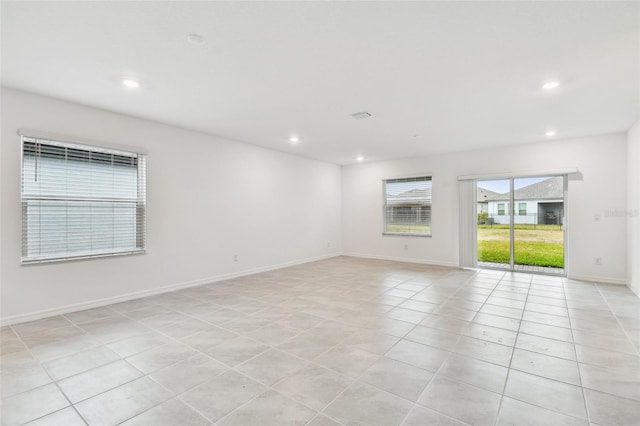 spare room featuring light tile patterned floors