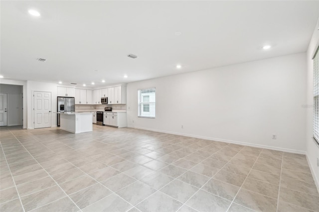 unfurnished living room with light tile patterned flooring