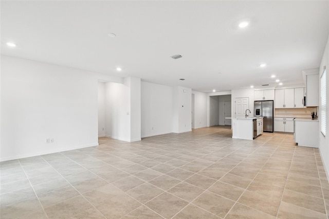 unfurnished living room with sink