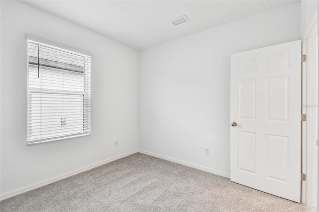 spare room with light colored carpet