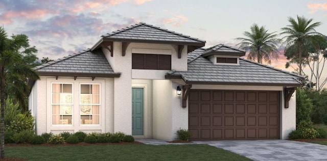 view of front facade featuring a garage and a lawn