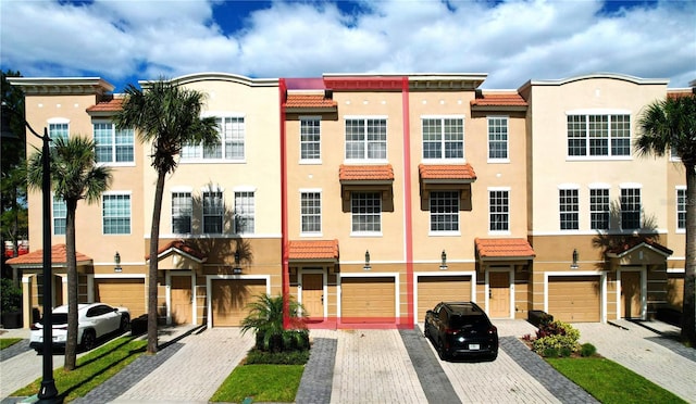 5002 Tideview Cir Unit 3, Orlando, FL 32819 - view of front of home with a tiled roof, stucco siding, and driveway