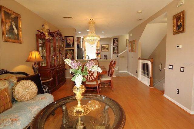 5002 Tideview Cir Unit 3, Orlando, FL 32819 - living room featuring visible vents, wood finished floors, baseboards, a notable chandelier, and recessed lighting