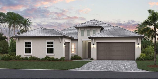 view of front facade featuring a yard and a garage