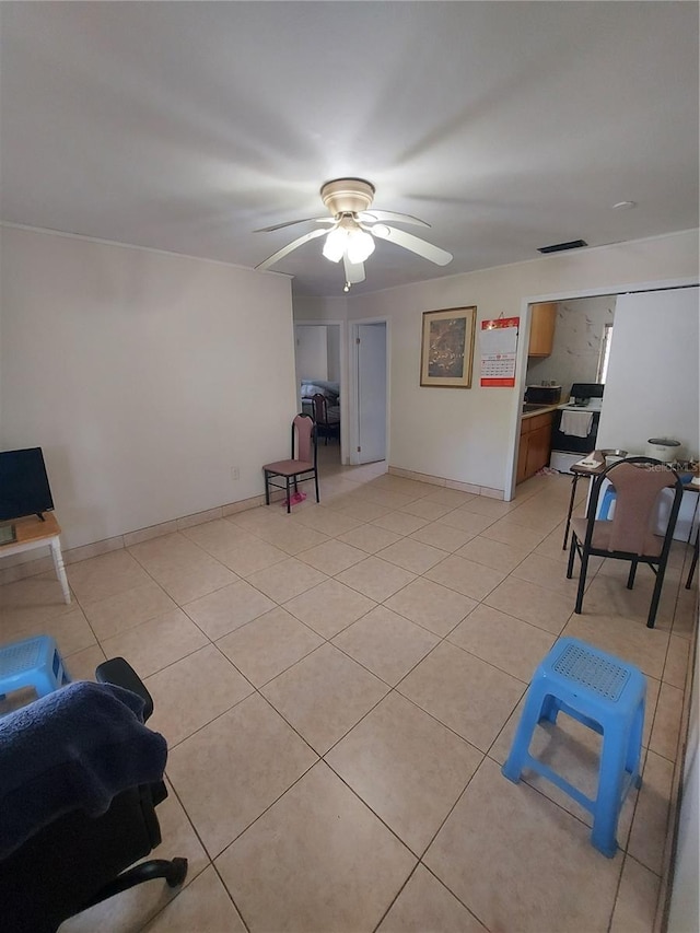 living room featuring light tile patterned flooring and ceiling fan