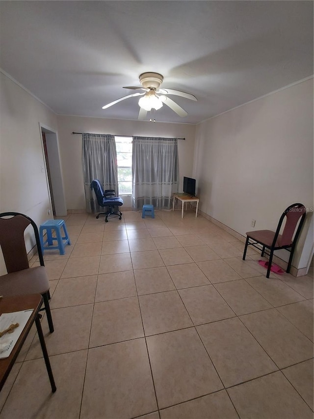 unfurnished room with crown molding, ceiling fan, and light tile patterned floors