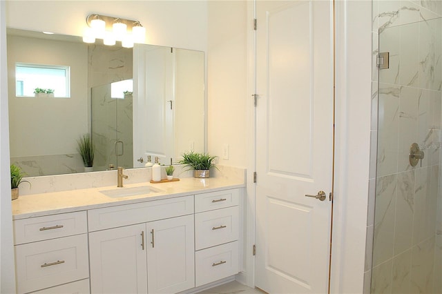 bathroom with vanity and a shower with shower door