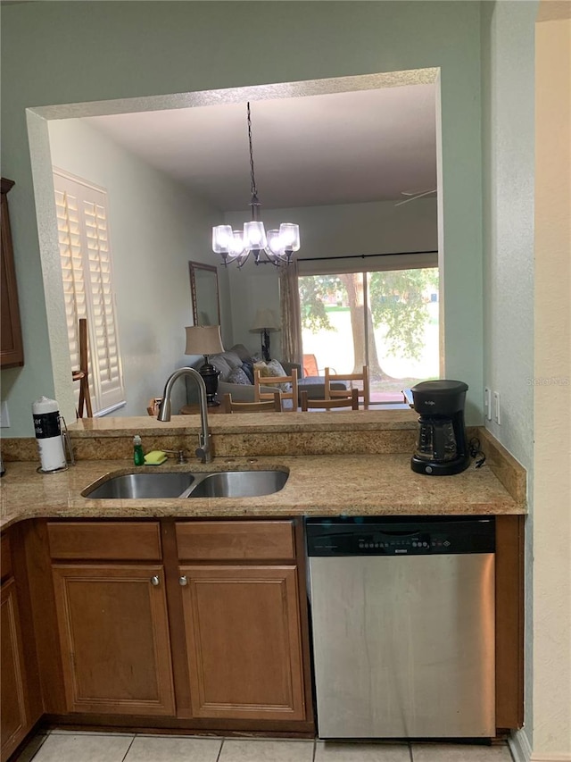 kitchen with sink, decorative light fixtures, stainless steel dishwasher, a notable chandelier, and light tile patterned floors