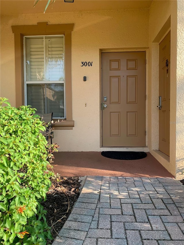 property entrance with stucco siding
