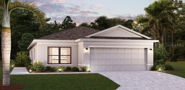 ranch-style home featuring a lawn and a garage