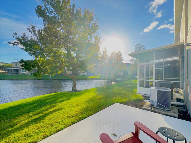 view of patio / terrace with a water view and a sunroom