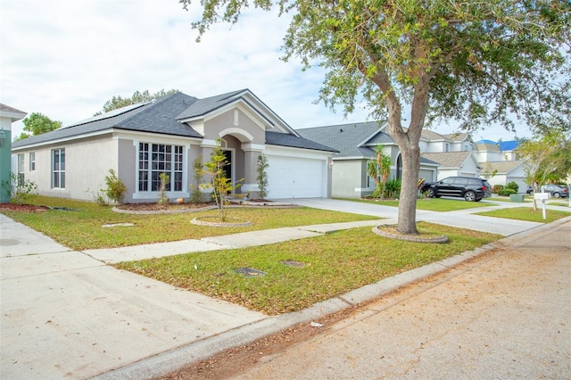 view of front of property featuring a garage and a front yard