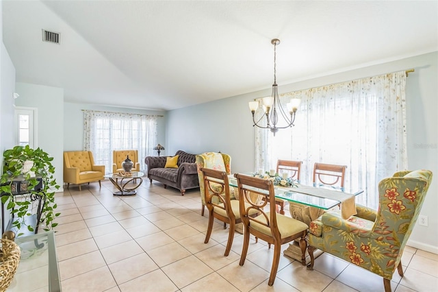 dining room featuring an inviting chandelier and light tile patterned floors