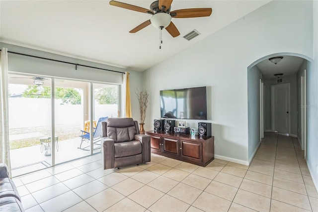 tiled living room featuring lofted ceiling and ceiling fan