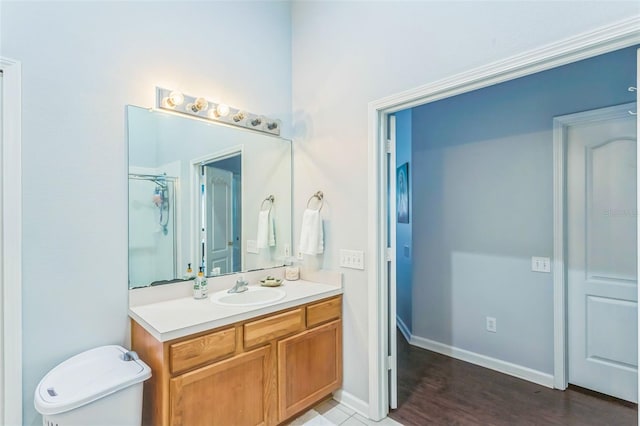 bathroom featuring hardwood / wood-style floors, vanity, toilet, and a shower with shower door