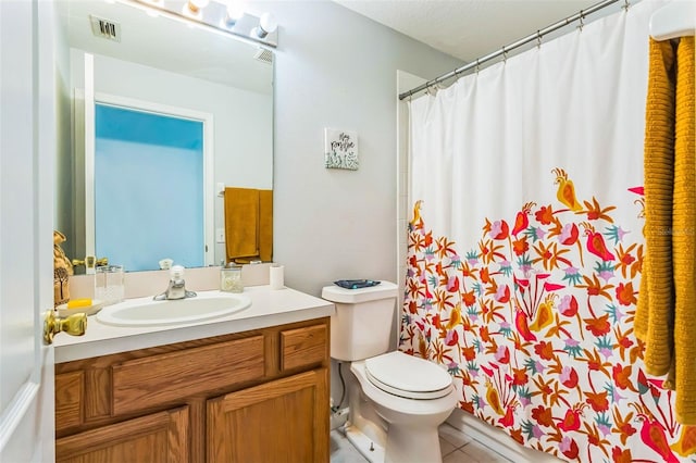 bathroom with vanity, tile patterned floors, and toilet