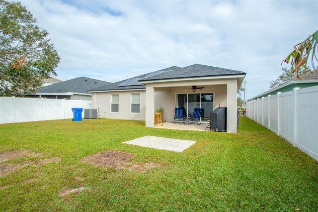 rear view of house with a patio, a lawn, central air condition unit, and ceiling fan