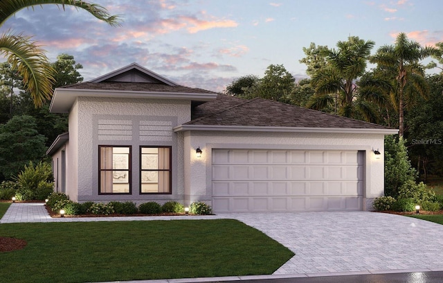 view of front of home with a garage and a yard