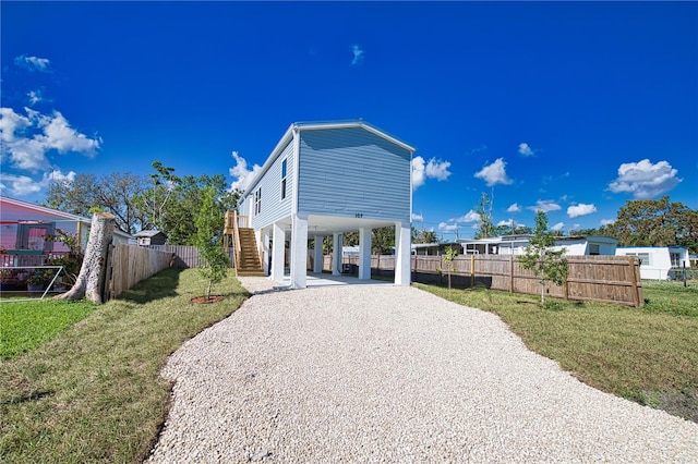 view of front facade with a carport and a front yard