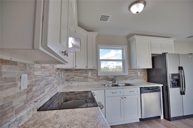 kitchen with white cabinets, sink, and stainless steel appliances