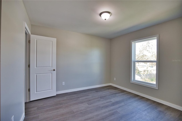 unfurnished room with hardwood / wood-style floors