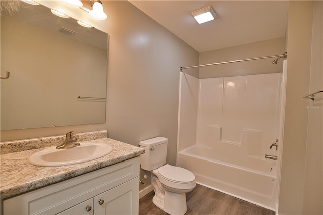 full bathroom with hardwood / wood-style flooring, vanity, toilet, and shower / bathing tub combination