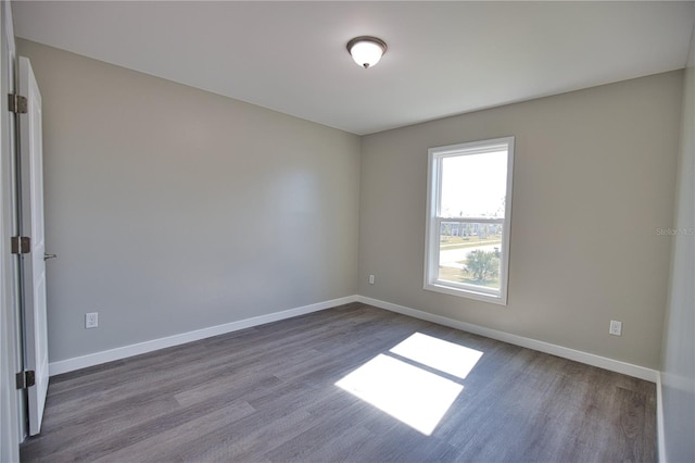 unfurnished room with hardwood / wood-style floors