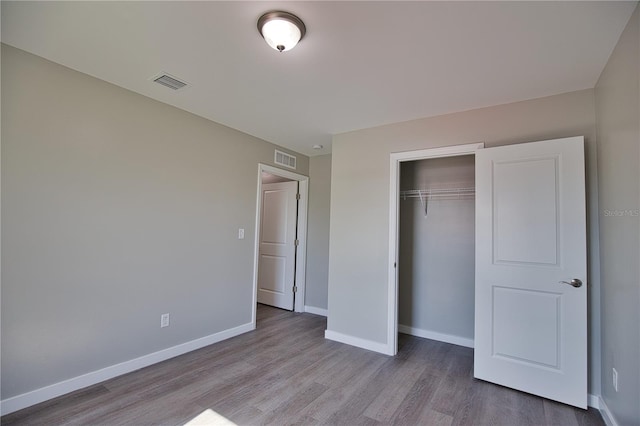 unfurnished bedroom featuring a closet and light hardwood / wood-style flooring