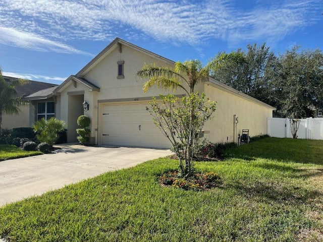 view of front of house featuring a garage and a front lawn