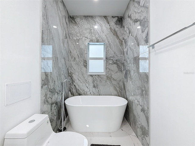 bathroom with a tub to relax in, toilet, and tile walls