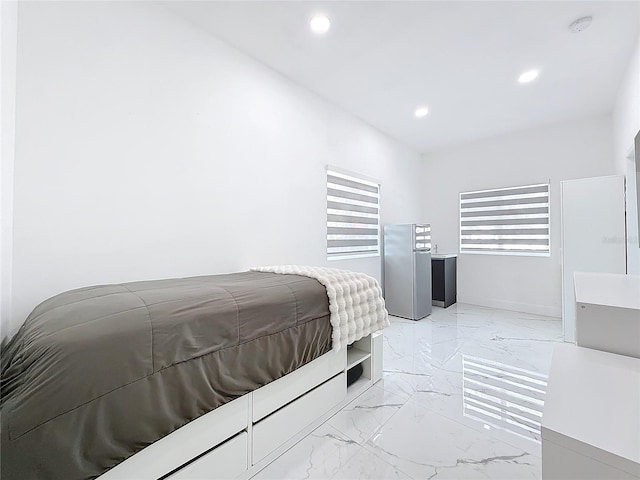 bedroom with stainless steel fridge