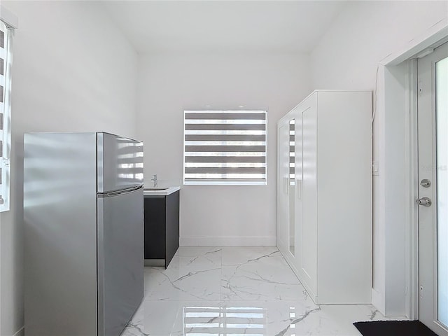 interior space featuring stainless steel fridge and sink