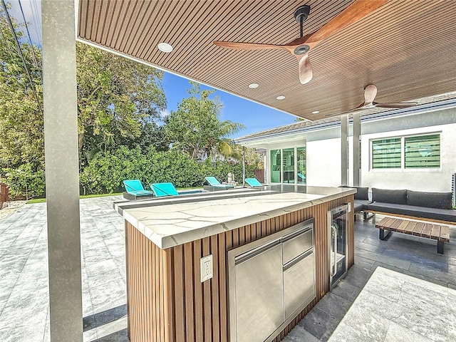 view of patio / terrace featuring wine cooler and ceiling fan