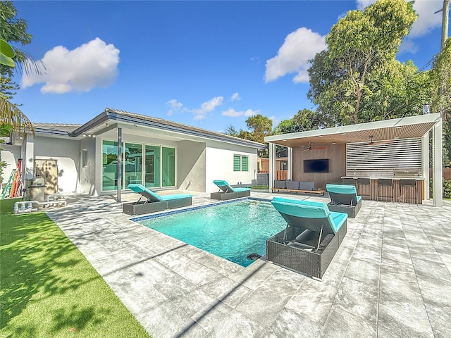 view of swimming pool featuring an outbuilding, an outdoor hangout area, and a patio area