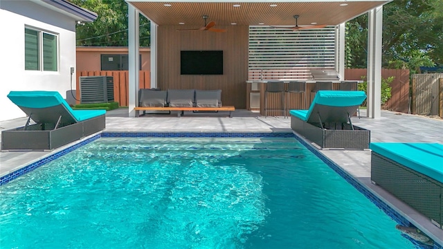 view of swimming pool featuring a patio area and ceiling fan