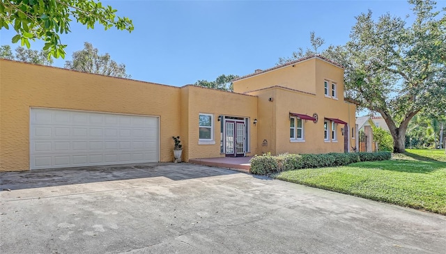 view of front of home featuring a garage and a front lawn