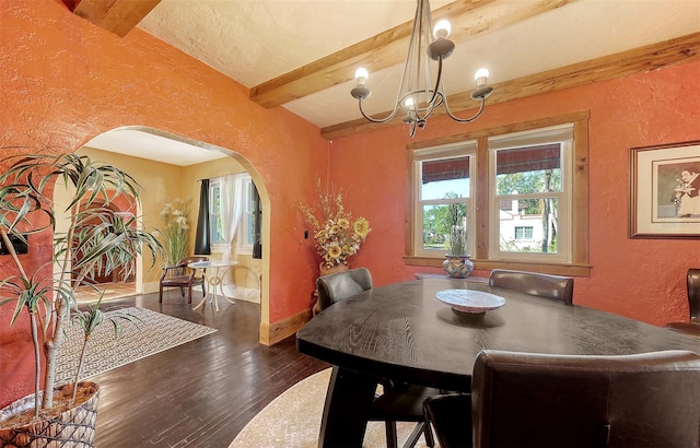 dining room with vaulted ceiling with beams, dark hardwood / wood-style flooring, and an inviting chandelier