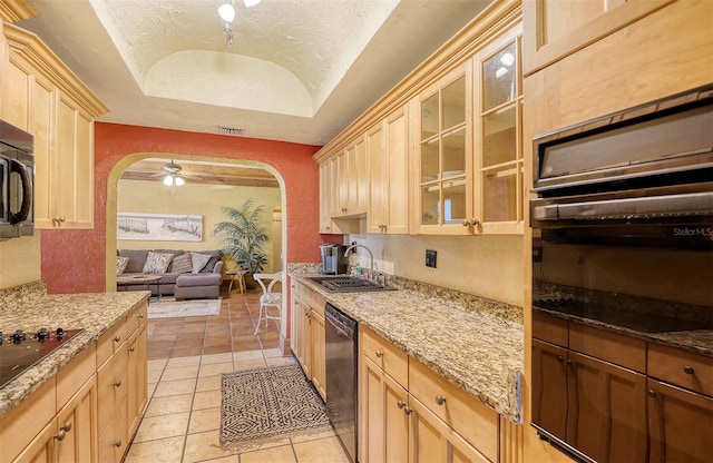 kitchen with lofted ceiling, black appliances, sink, ceiling fan, and light tile patterned floors