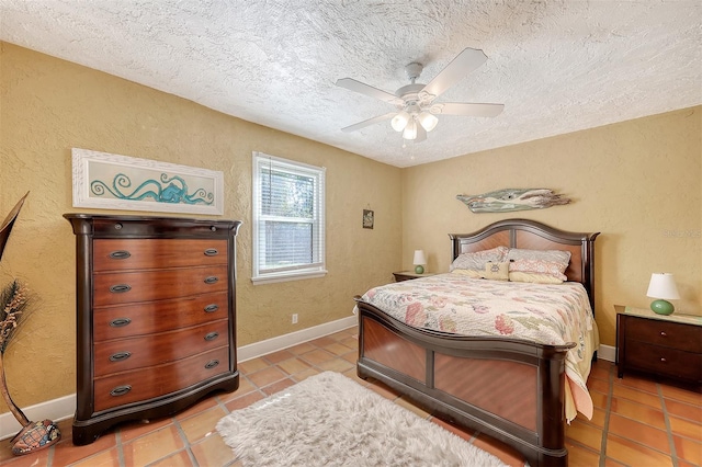 tiled bedroom featuring a textured ceiling and ceiling fan