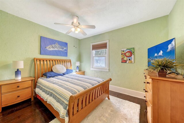 bedroom featuring dark hardwood / wood-style floors and ceiling fan