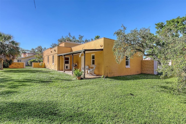 back of house featuring a yard and a patio