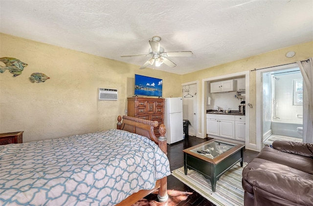 bedroom with ceiling fan, dark wood-type flooring, sink, white refrigerator, and connected bathroom