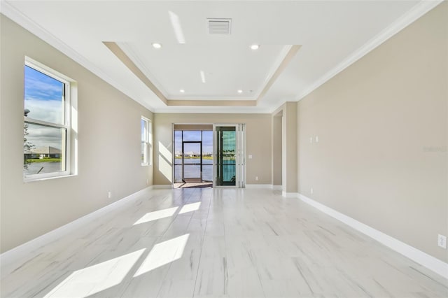 empty room with a tray ceiling and crown molding