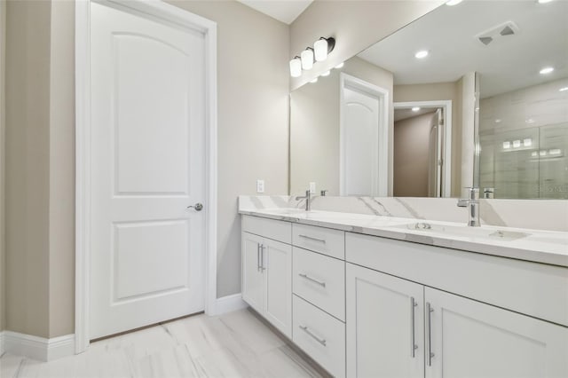 bathroom with vanity and a shower with shower door